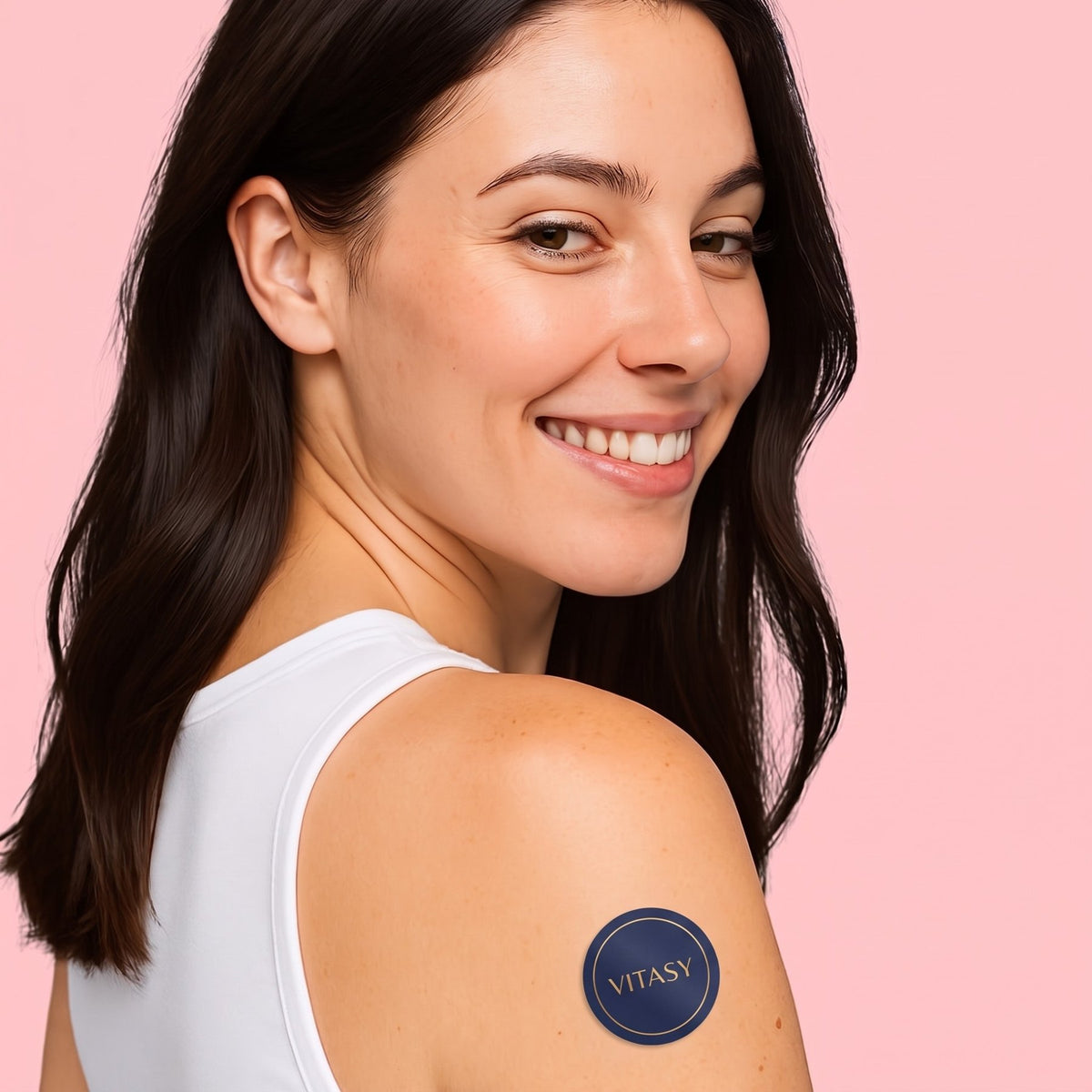 Smiling woman wearing an Energy Patch on her shoulder