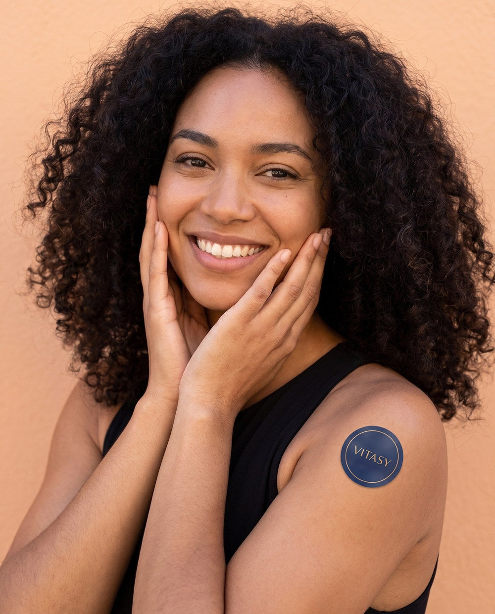 Smiling woman wearing a Vitasy energy patch
