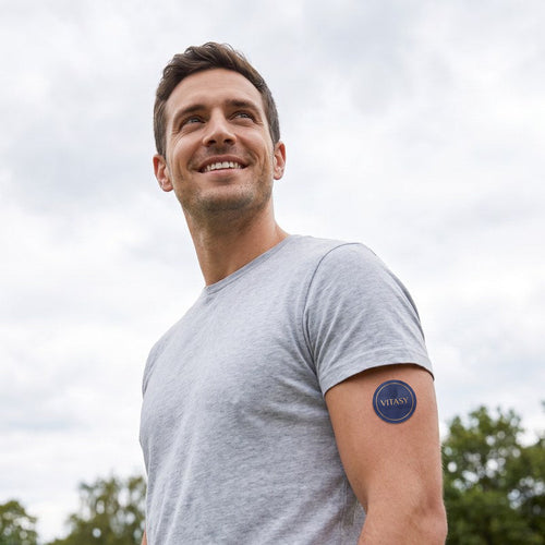 Man wearing a Vitasy Energy Patch on his upper arm outdoors
