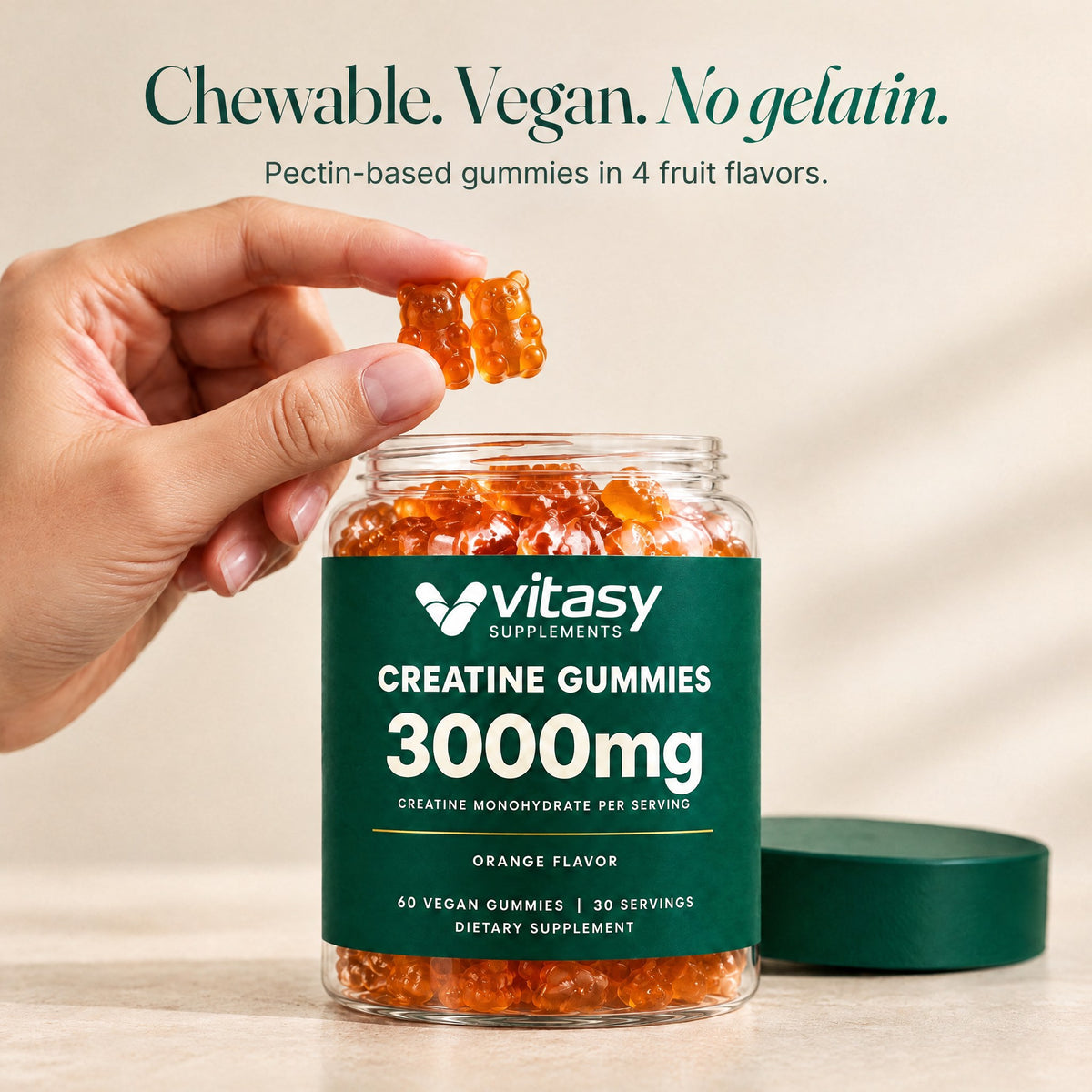 Hand taking a vegan creatine gummy from the Vitasy jar: chewable, vegan, no gelatin