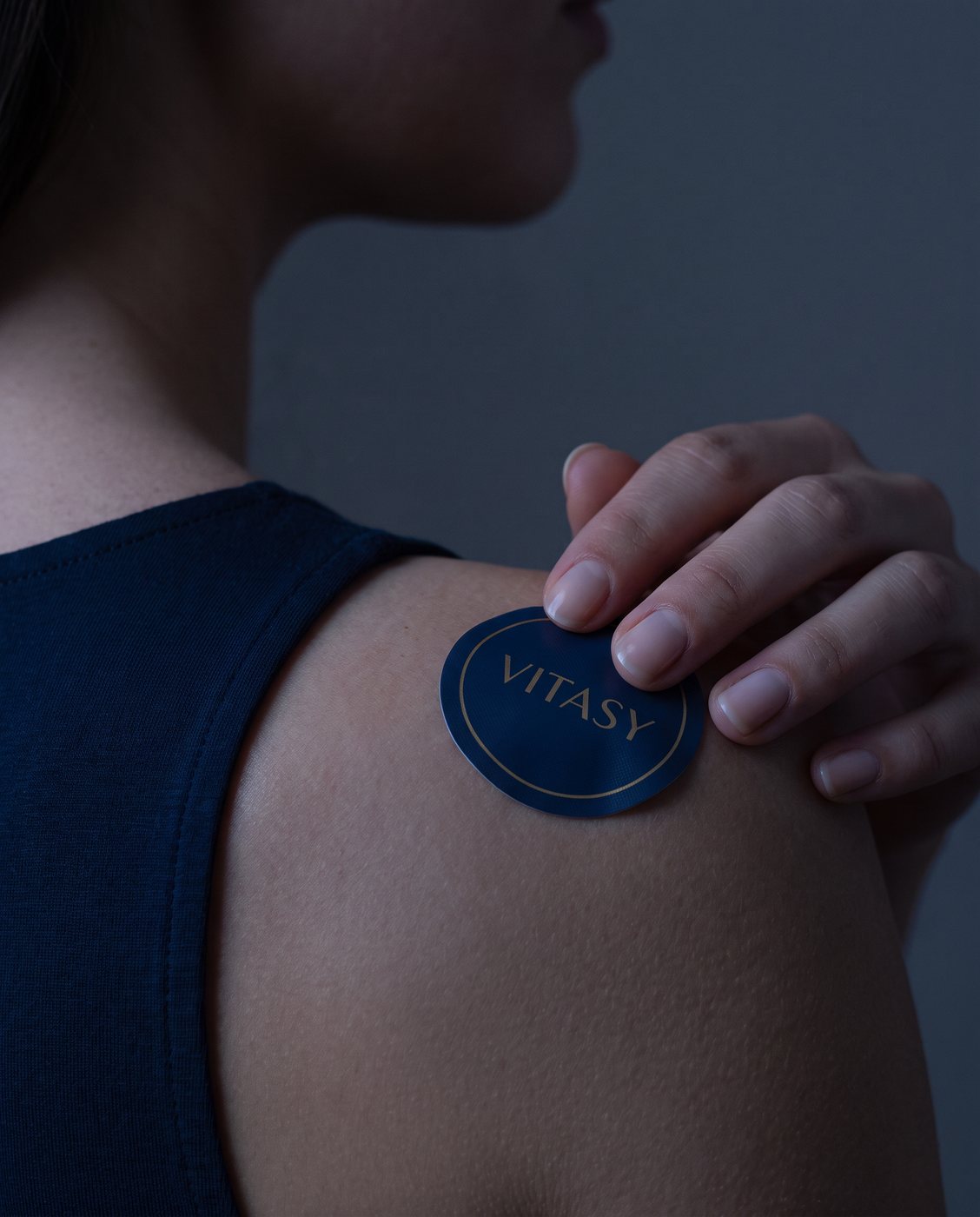 Applying a Vitasy patch to the shoulder
