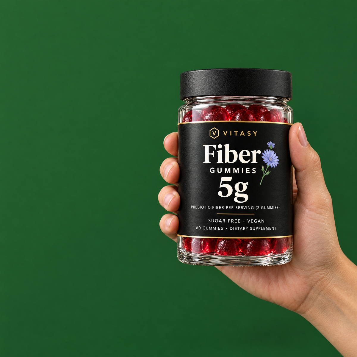 Hand holding a jar of Vitasy Fiber Gummies