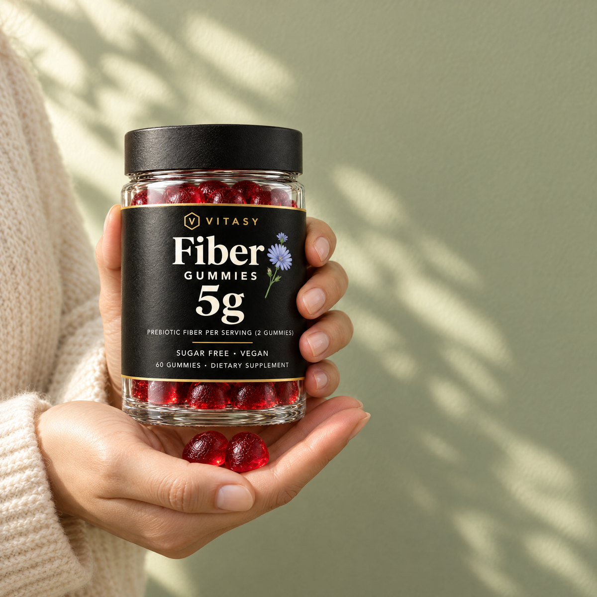 Hands holding a jar of Vitasy Fiber Gummies