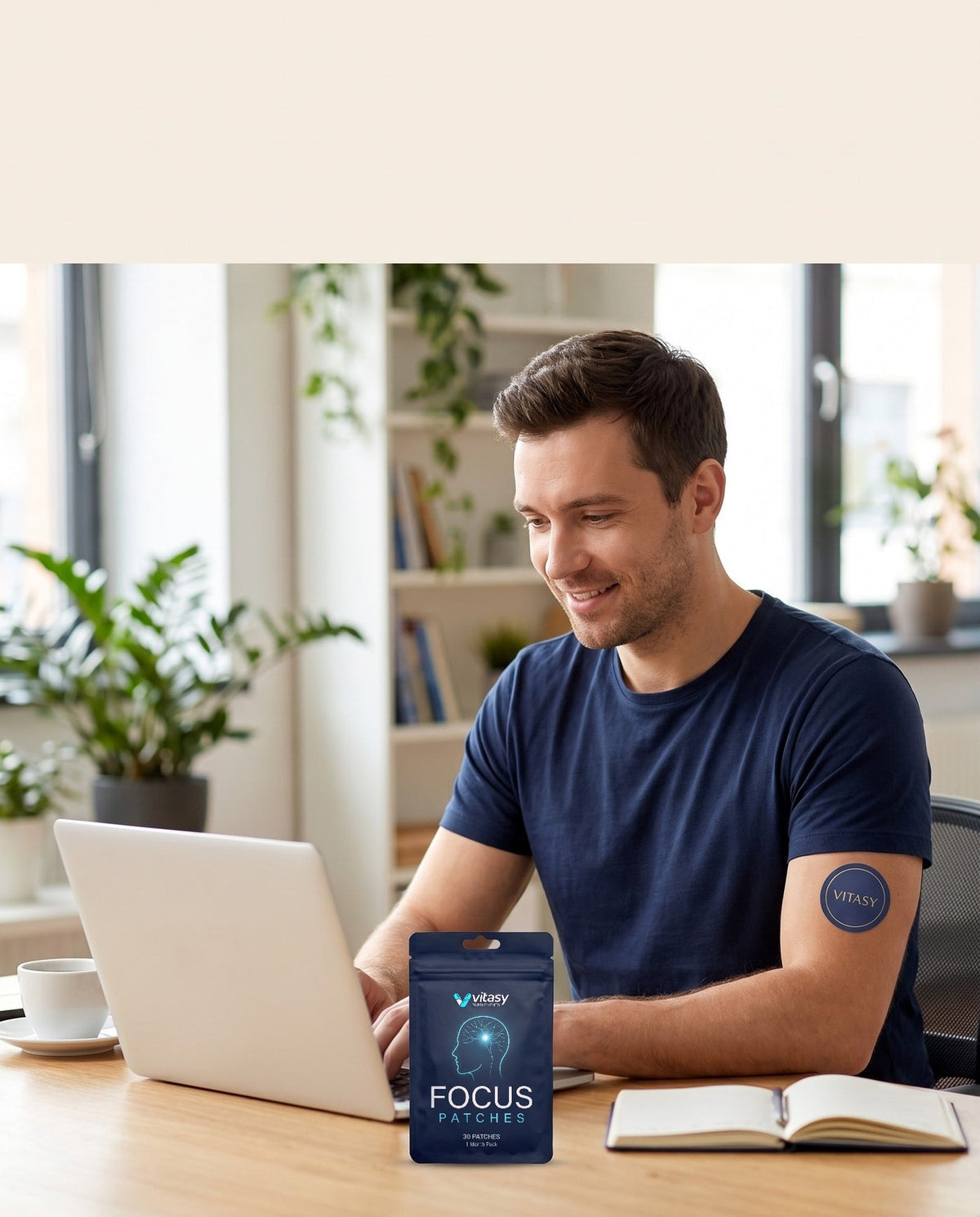 Man working at his desk with a Vitasy patch on his upper arm