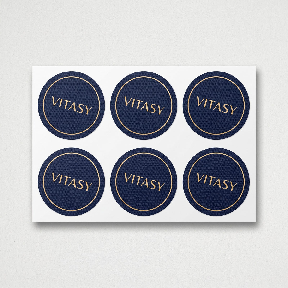 Sheet of round navy Vitasy patches, top view