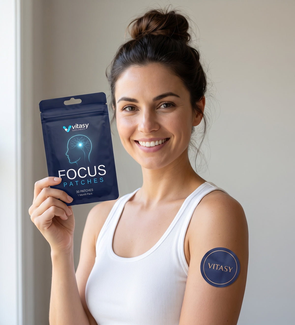 Smiling woman holding a pouch of Vitasy Focus Patches