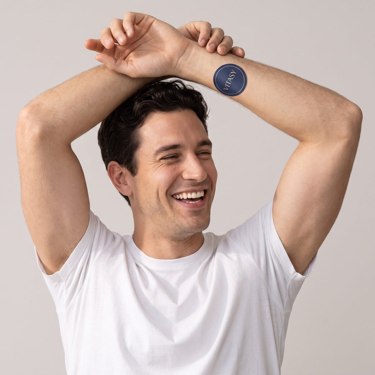 Smiling man with a Vitasy patch on his forearm