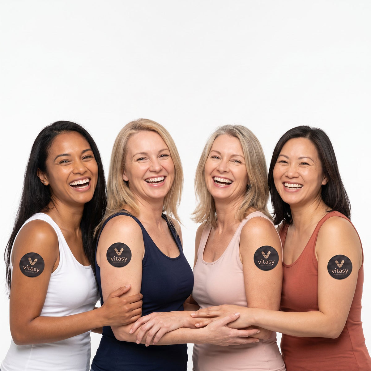 Four women wearing Vitasy patches on their upper arms