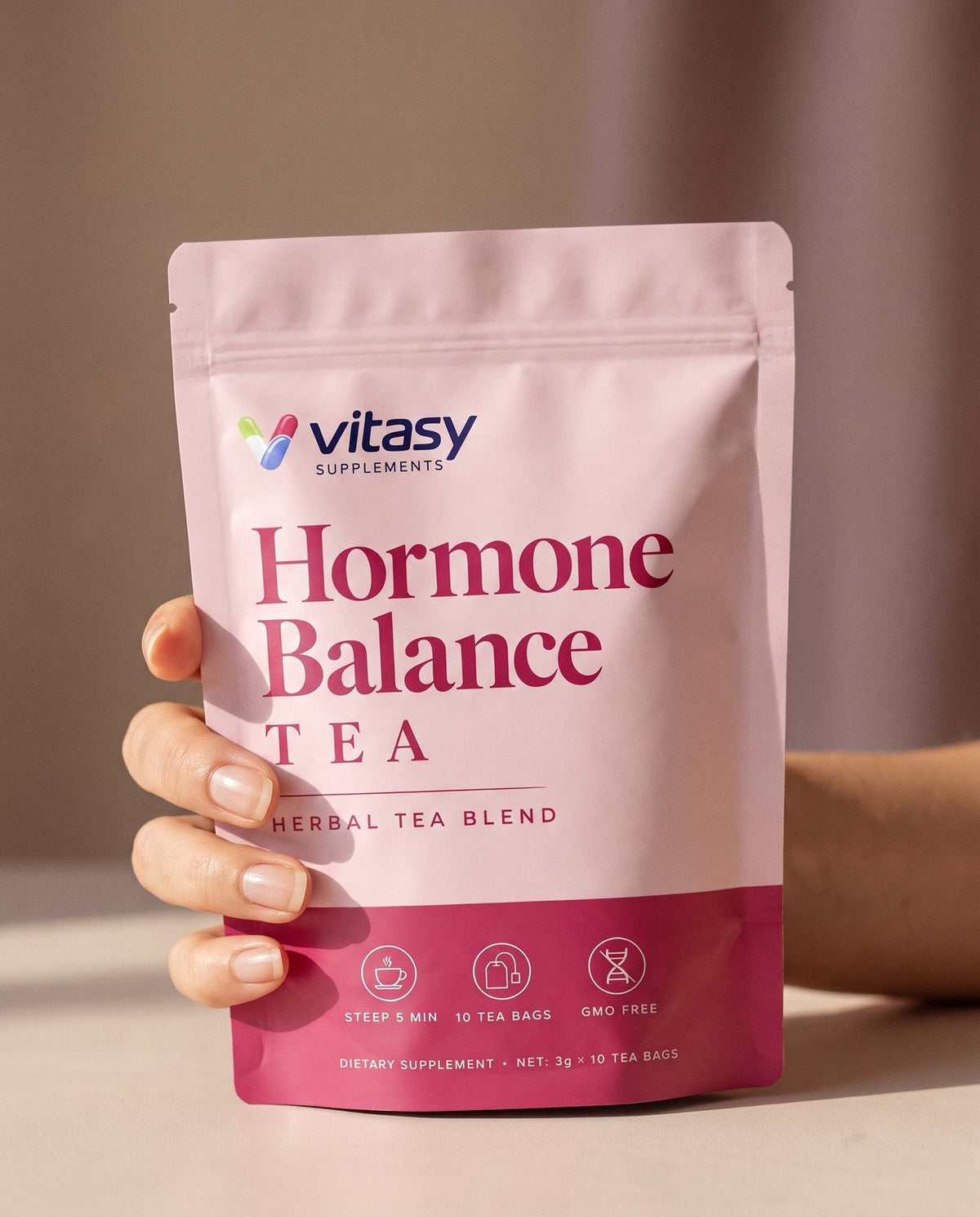 Hand holding the Vitasy Hormone Balance Tea pouch
