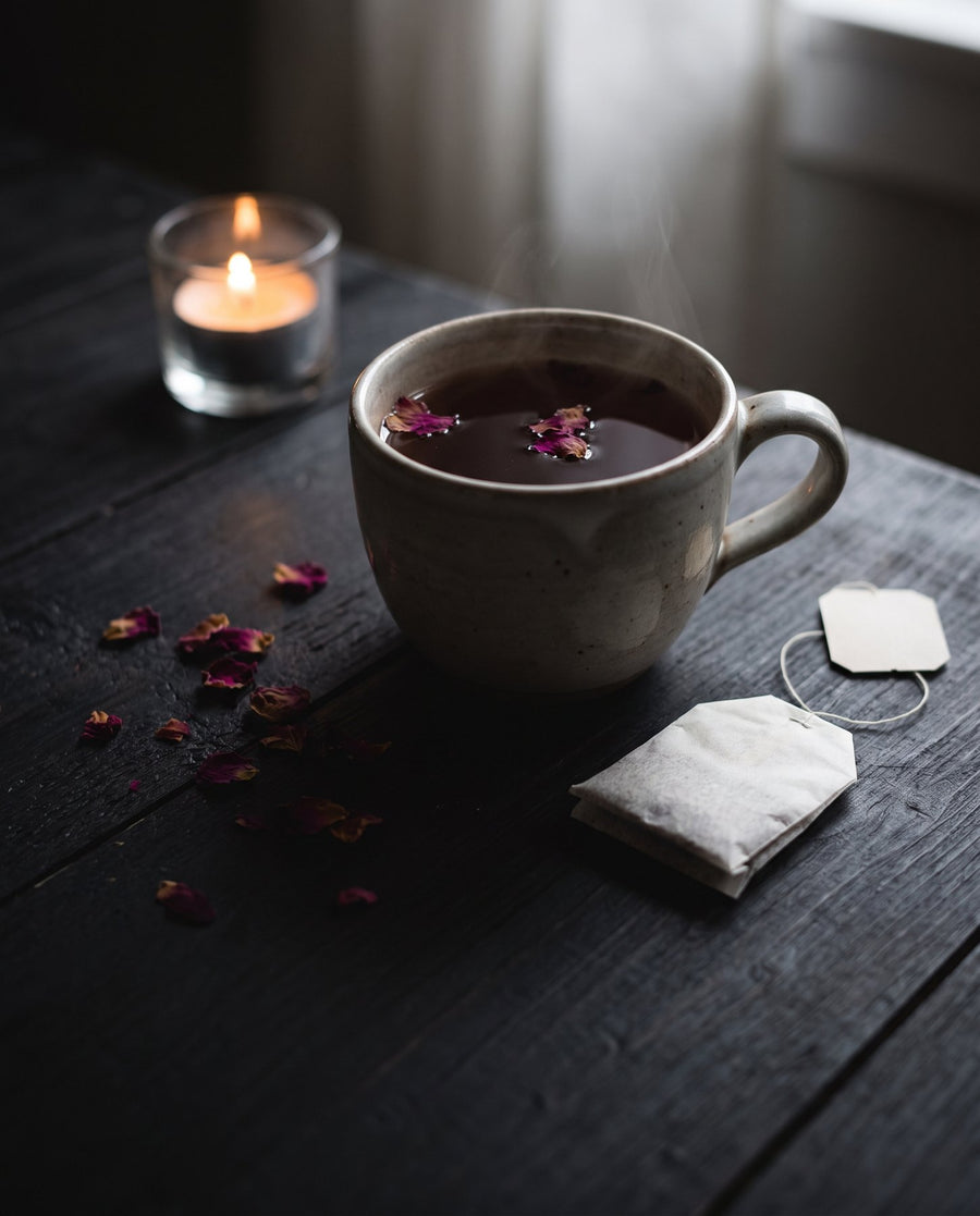 Cup of rose tea on a dark table