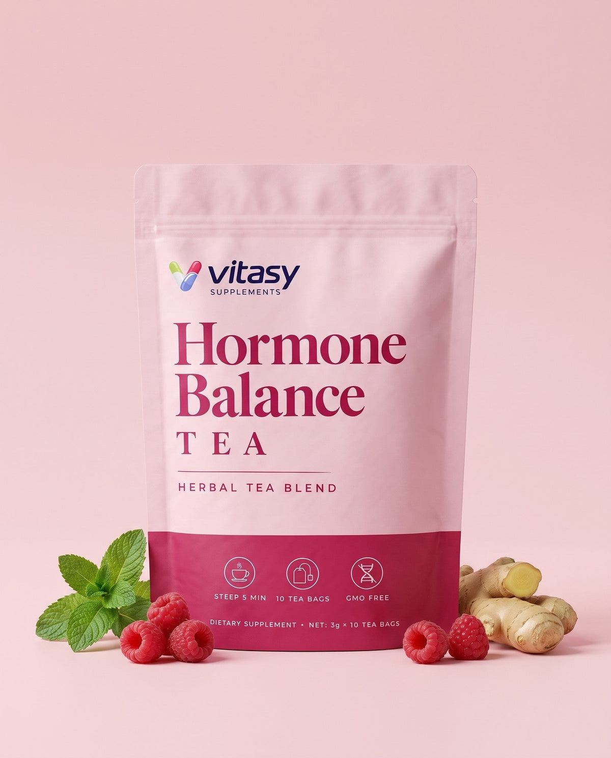 Vitasy herbal tea pouch on a pink background with raspberries, spearmint and ginger root
