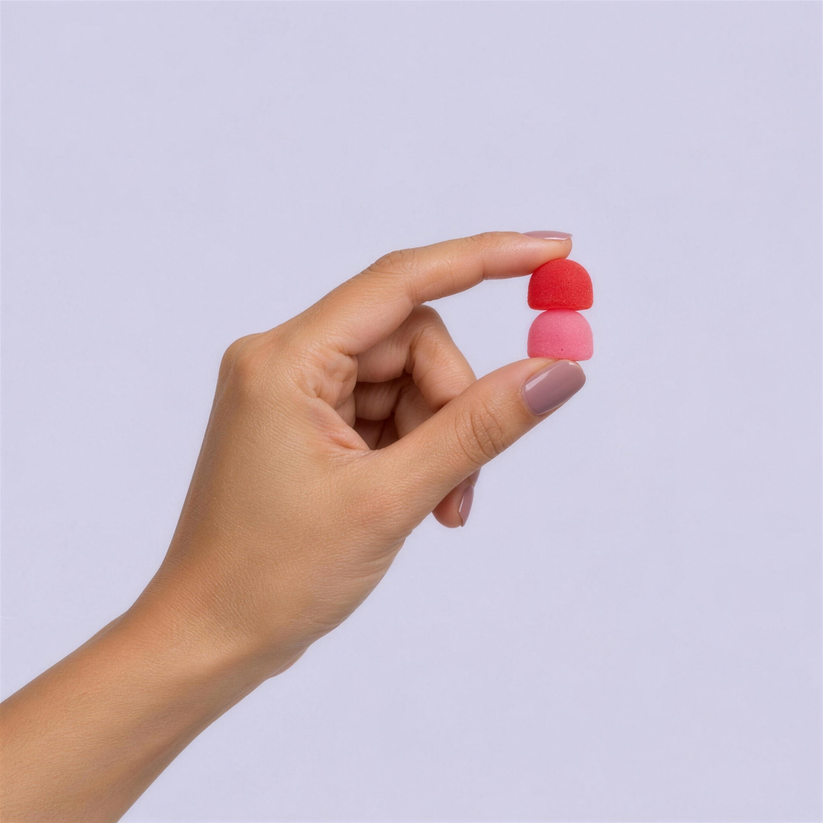 Hand holding a serving of two fiber gummies
