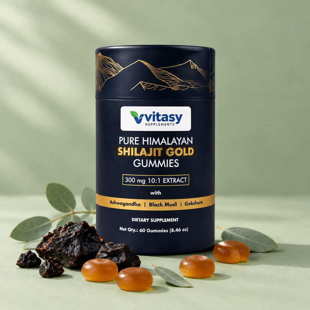 Shilajit Gold Gummies tube on a sage green surface with raw shilajit resin, amber gummies and eucalyptus leaves