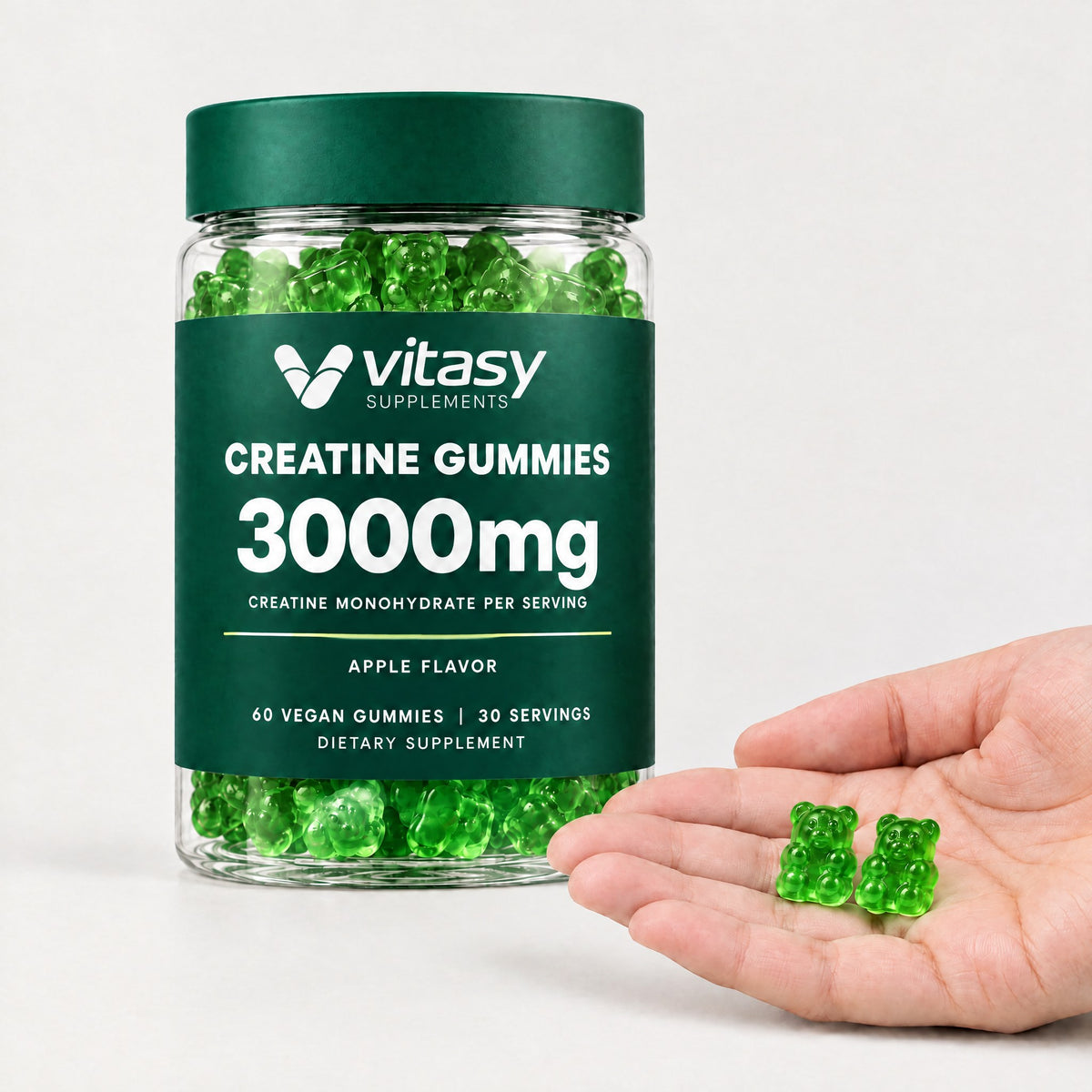 Two apple Vitasy creatine gummies in an open hand next to the jar