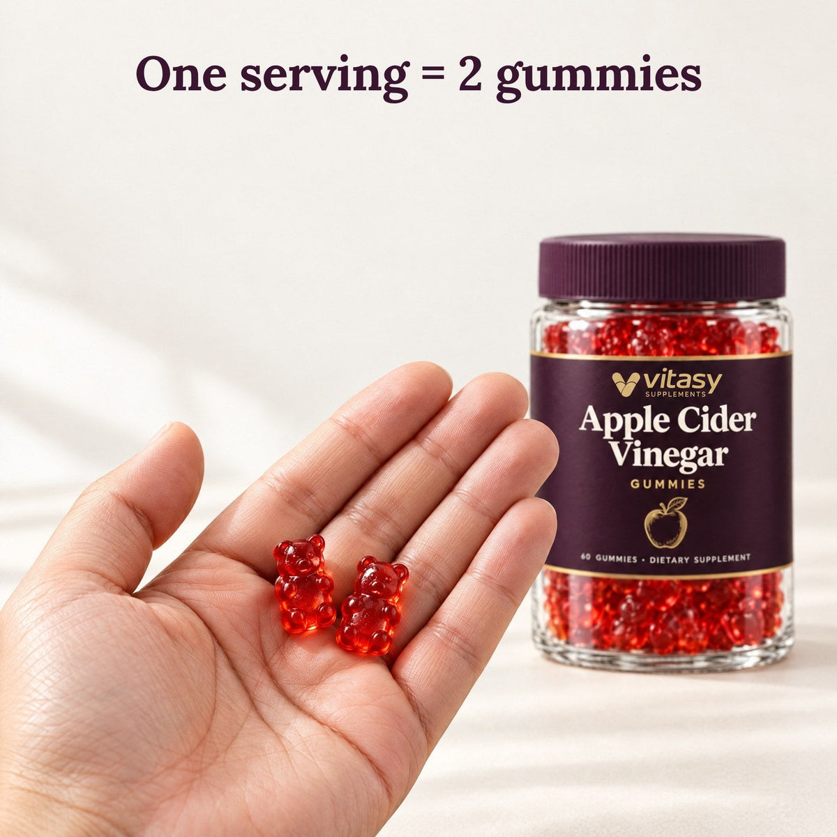 One serving is 2 gummies: two red gummy bears in an open hand