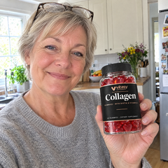Woman in reading glasses reading the Vitasy jar in her kitchen