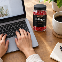 Hands on a laptop keyboard next to the Vitasy jar