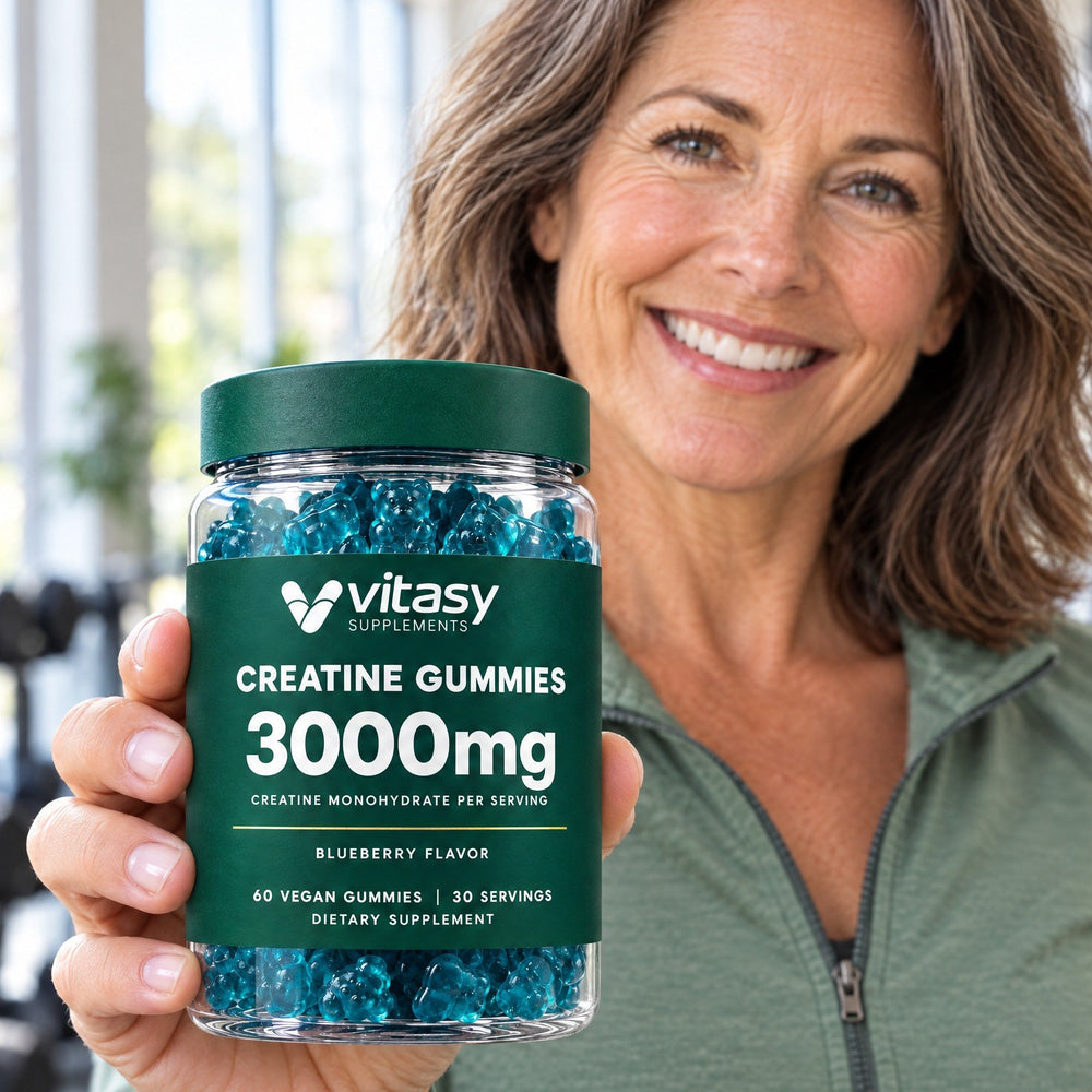 Woman in a bright gym holding a jar of Vitasy Creatine Gummies