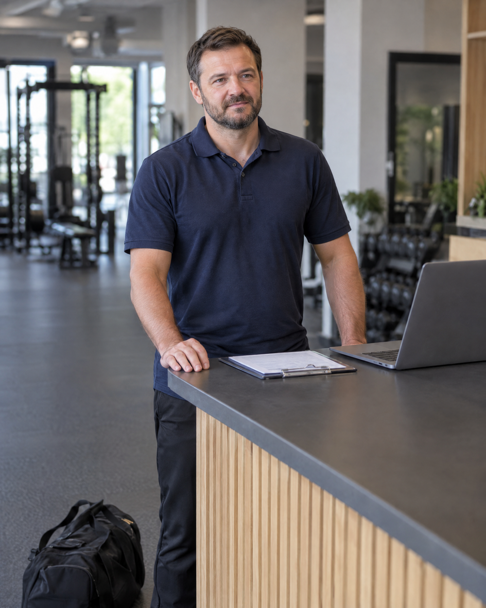 Strength coach at a gym front desk