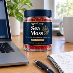Vitasy Sea Moss jar on a desk next to a laptop