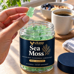 Hand taking a mint gummy from the Vitasy jar at breakfast