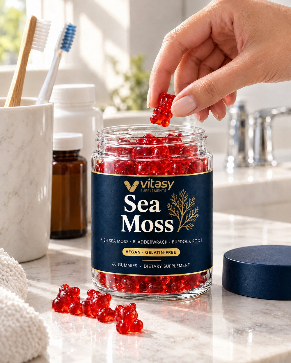 Woman's hand taking a gummy from the Vitasy jar next to her vitamins