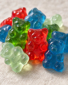 Blue, red, green and mint Vitasy sea moss gummy bears close up