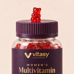 Colorful Vitasy multivitamin gummies (strawberry red, orange, blueberry, cherry) next to the jar