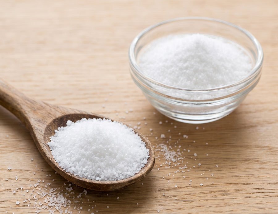 TMG powder in a glass bowl with a wooden spoon