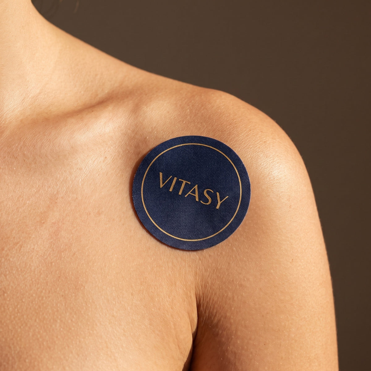 Close-up of a shoulder wearing a Vitasy patch
