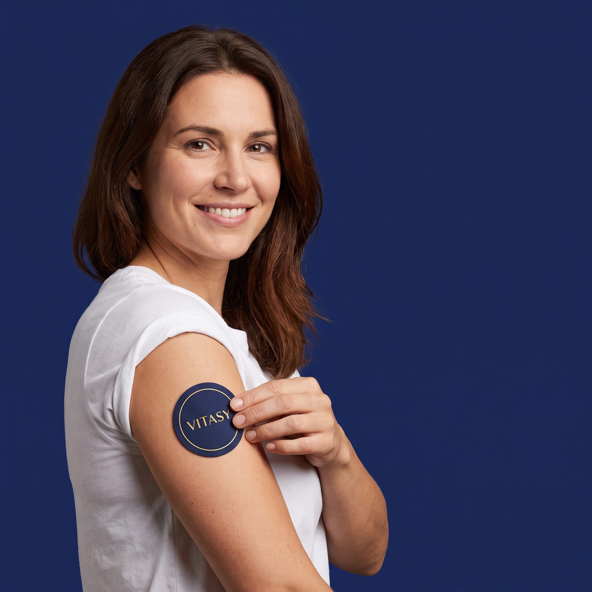 Woman applying a Vitasy NAD+ patch to her upper arm