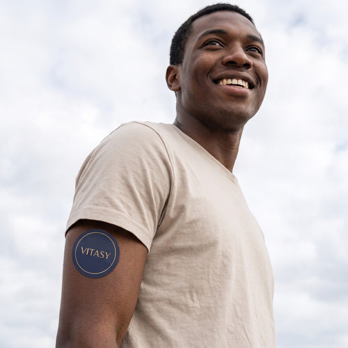 Man outdoors with a Vitasy patch on his upper arm