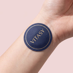 Navy Vitasy patch on the wrist