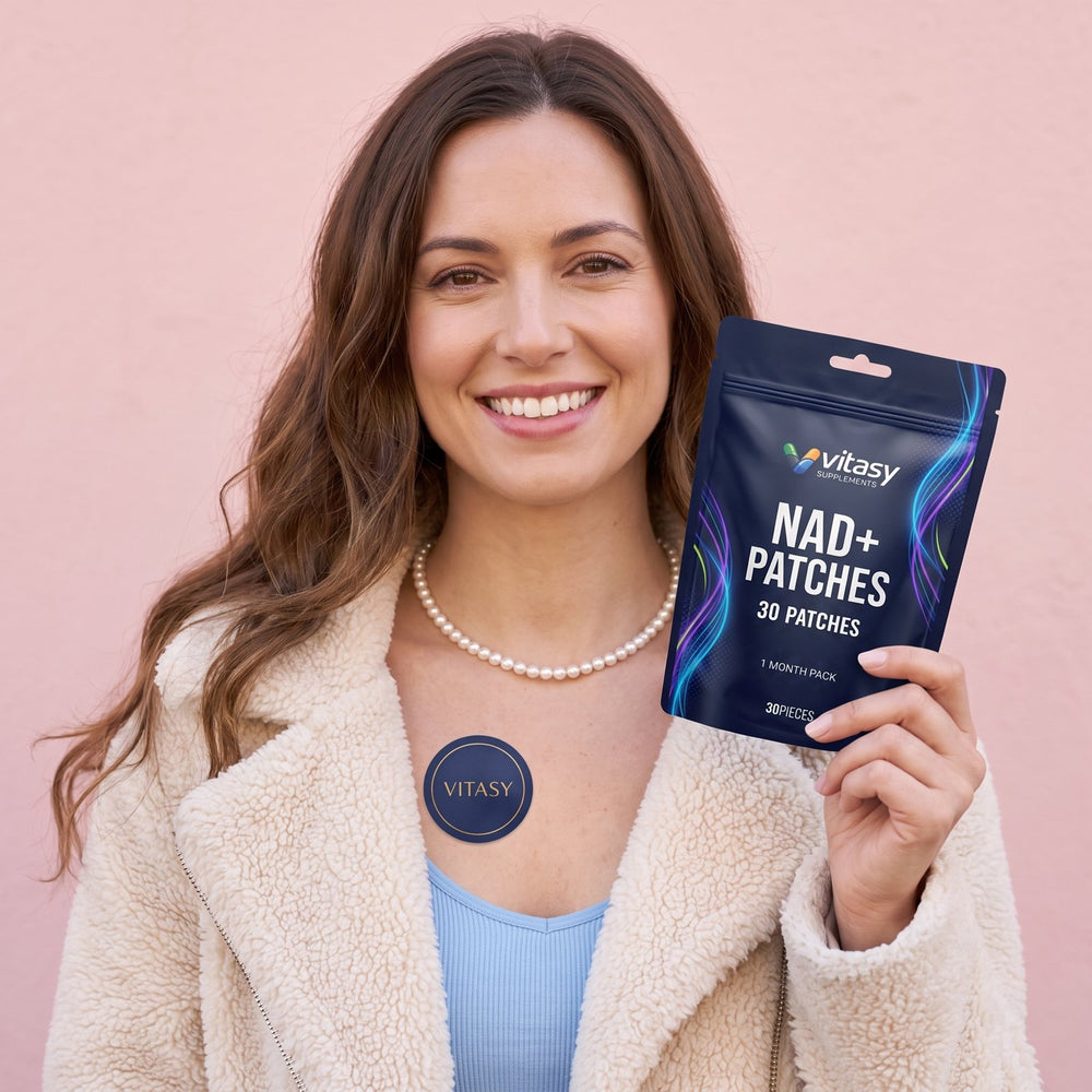 Woman with a navy Vitasy patch on her upper chest holding the NAD+ Patches pouch
