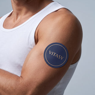 Man wearing a Vitasy patch on his upper arm