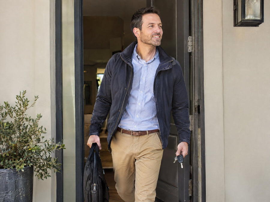 Man heading out the door early with a laptop bag