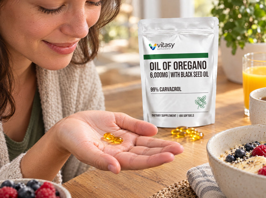 Palm holding two golden oregano softgels