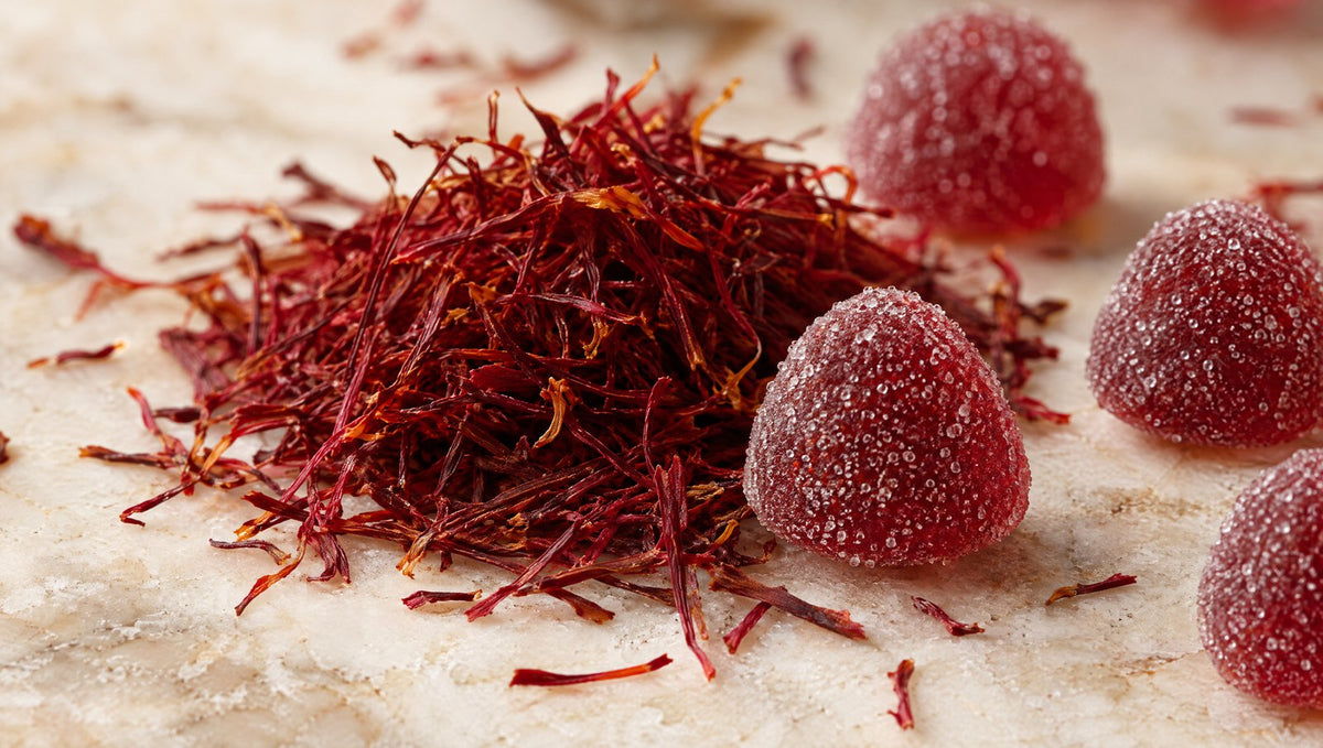 Close-up of saffron threads and sugar-coated red gummies