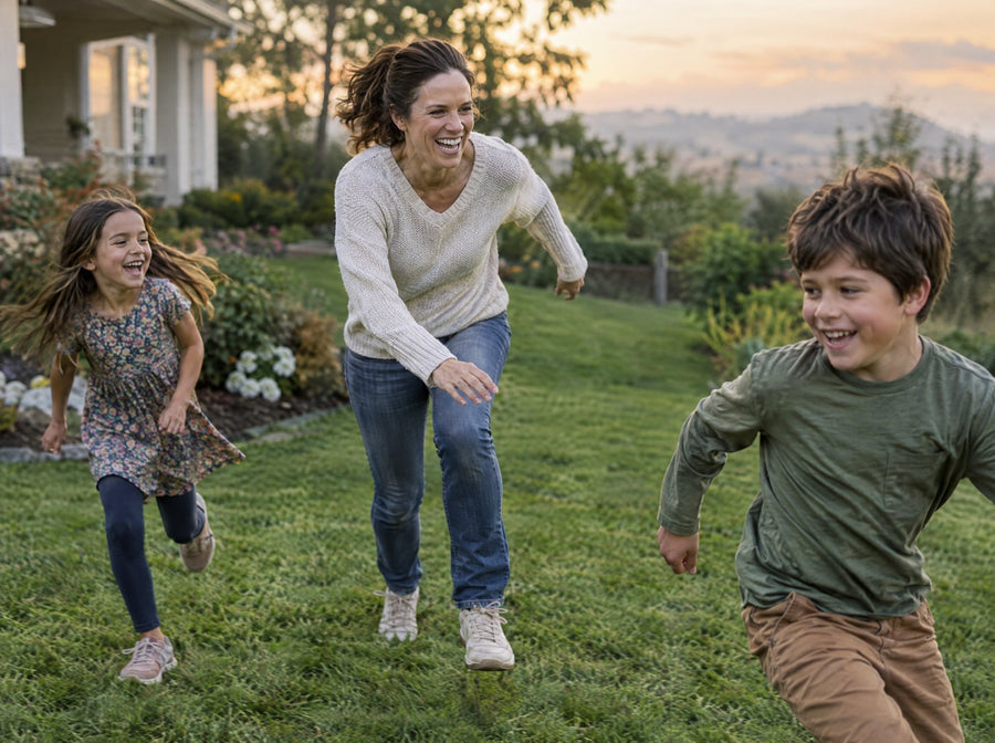 Mother playing with her kids on a lawn in the evening