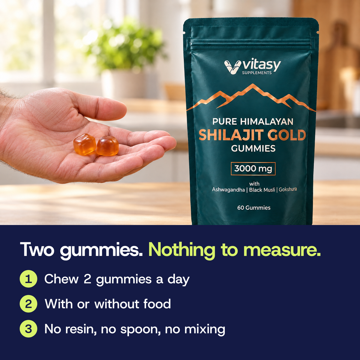 Hand holding two shilajit gummies in a kitchen next to the pouch. Chew 2 gummies a day, with or without food.
