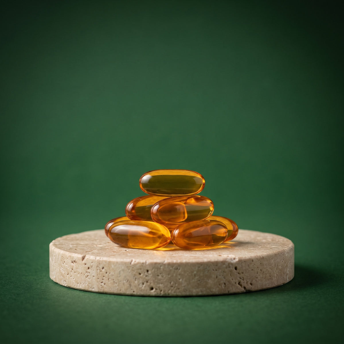 Stack of oil of oregano softgels on a stone pedestal