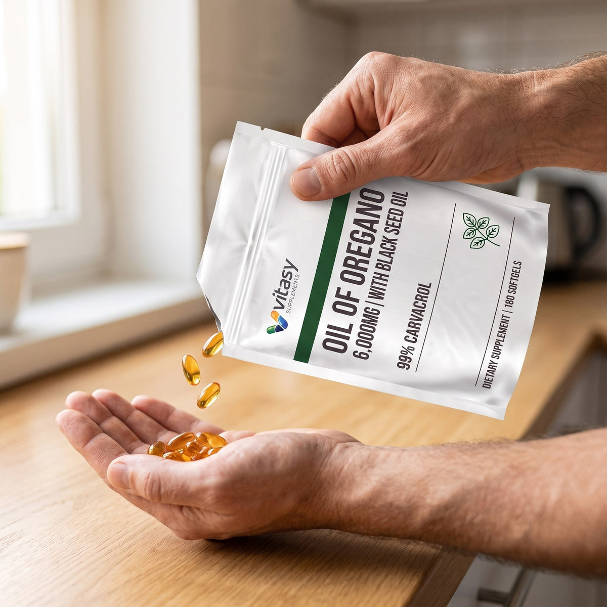 Softgels poured from the Vitasy Oil of Oregano pouch into a hand