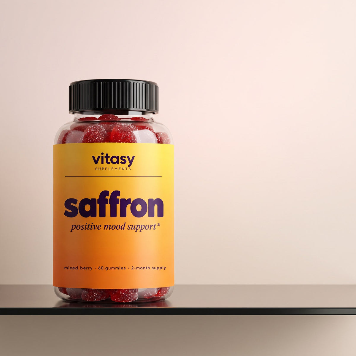 Vitasy Saffron Gummies bottle on a warm beige ledge