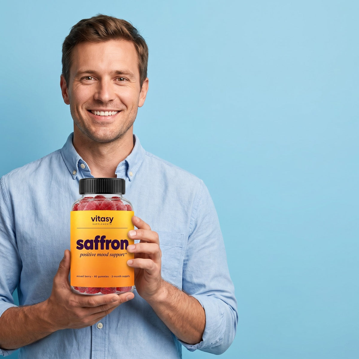 Supplement Facts for Vitasy Saffron Gummies, held by a smiling dad