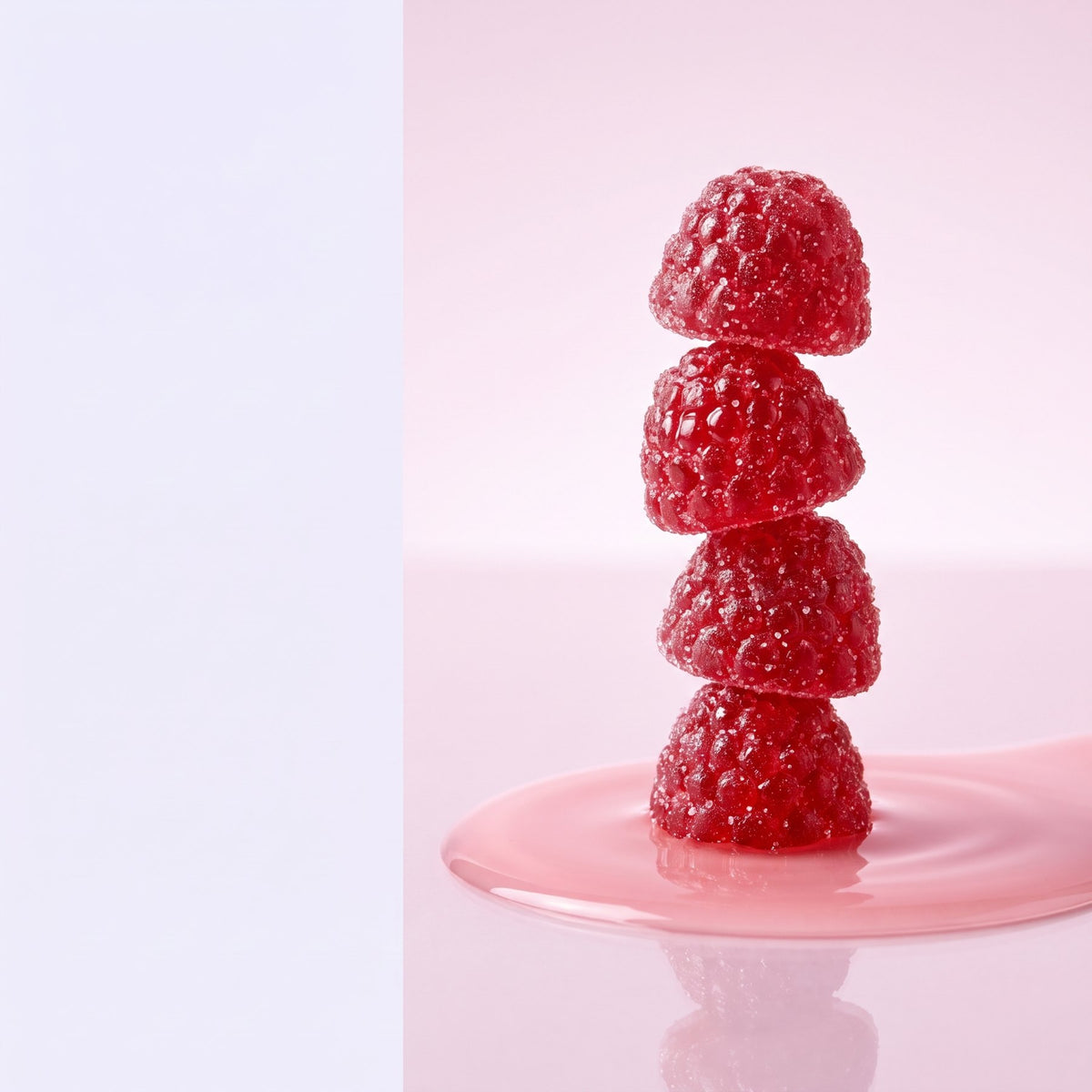 Stack of red mixed berry gummies on a soft pink surface
