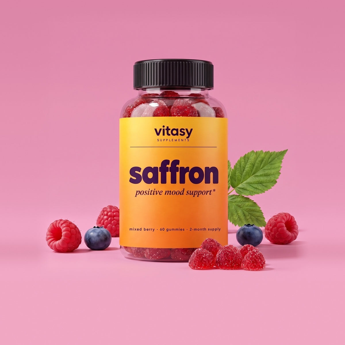 Vitasy Saffron Gummies bottle with raspberries on a pink background