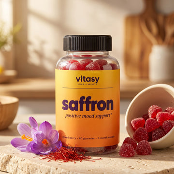 Vitasy Saffron Gummies bottle with saffron threads, crocus flowers and mixed berry gummies