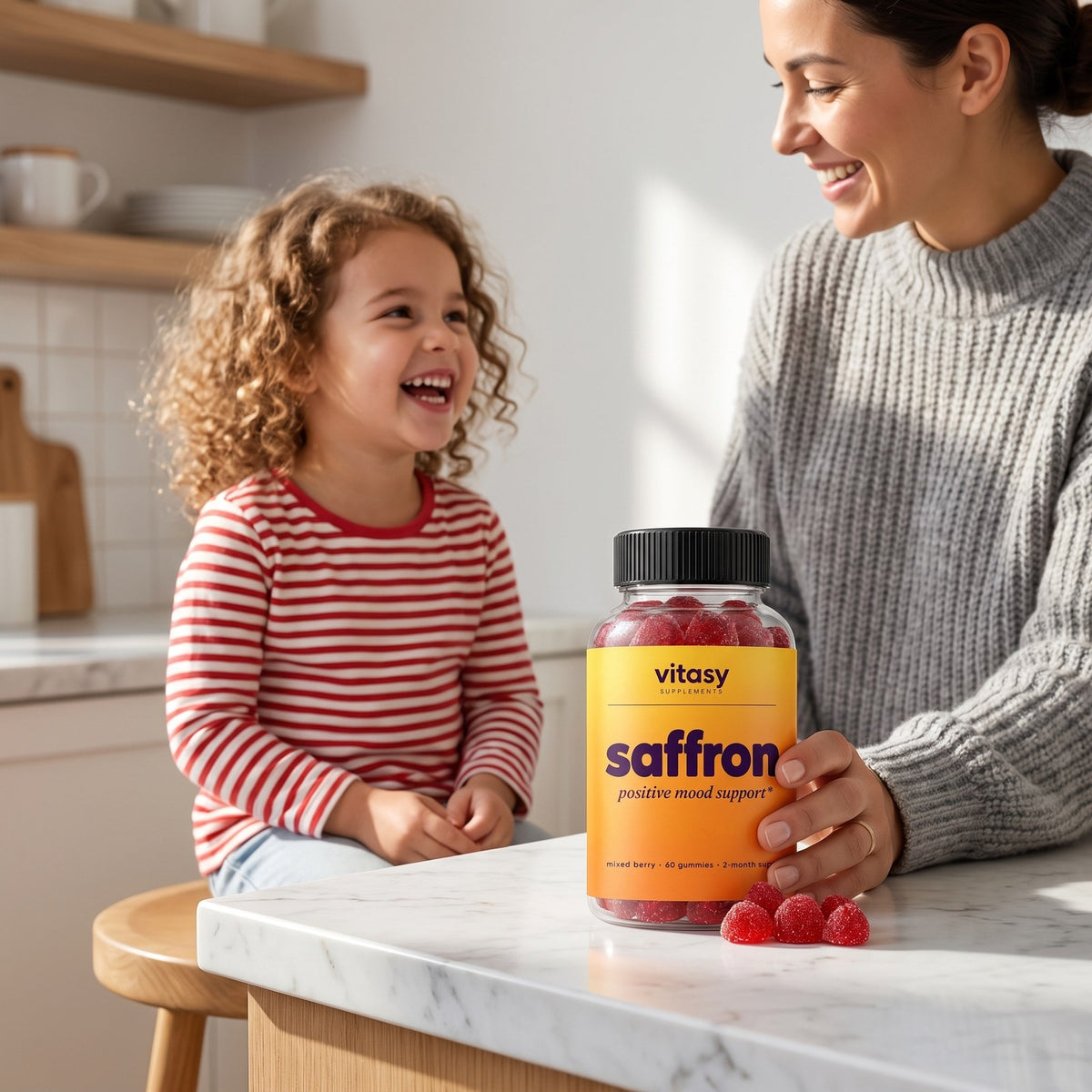 Mom and daughter in the kitchen with a bottle of Vitasy Saffron Gummies