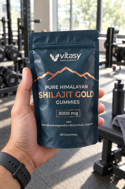 Hand holding a pouch of Vitasy Shilajit Gummies at the gym