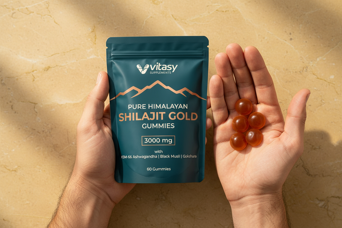 Vitasy Shilajit Gold Gummies pouch held in one hand with gummies in the other